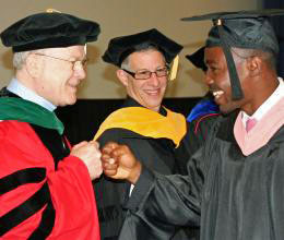 Graduation congratulations! Red-letter day for MPH graduate Ibrahim Ali, with UW Global Health chair Dr. King Holmes. (Photo: Bliss Ali)
